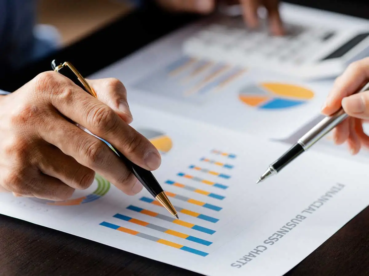 Two people reviewing a business valuation chart